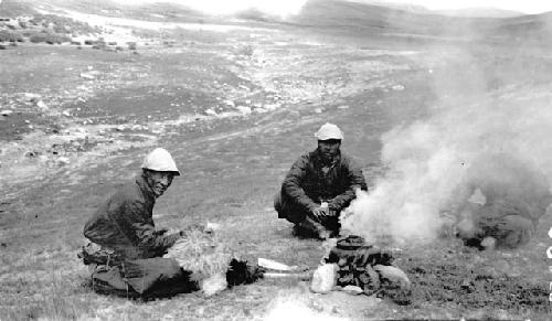 Men preparing food in desert