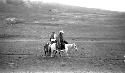 People riding ponies in desert