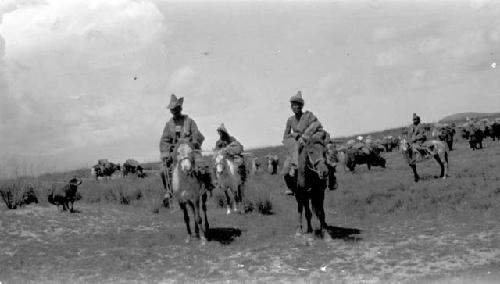 People riding ponies in the desert