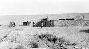 Man walking by building complex in desert