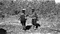 Men standing on a dirt road