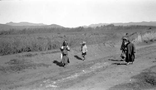 People walking along road