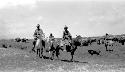 People riding ponies in the desert