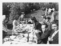 Gordon Willey in Fedora-rear left-seated at picnic table with others