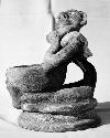 Pot 17, Grave 2. Pottery figure seated on low platform holding a small bowl