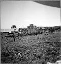 Castillo (Str. 1) from South doorway of Cenote House (Str. 35)