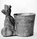 Effigy vessel, ceramic, crouching animal with vase attached to back, incised