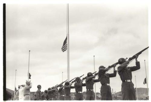 Soldiers firing rifles at U.N. cemetery ceremony