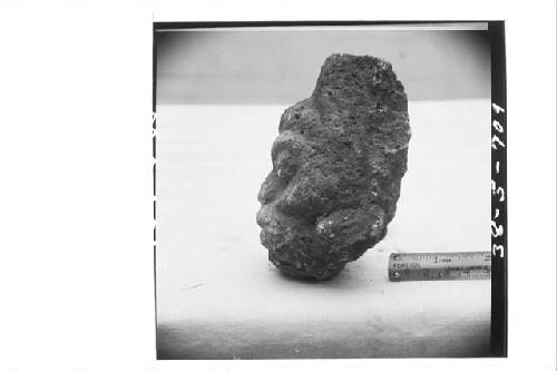 Left profile of small stone human head