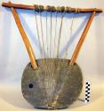 Stringed instrument, wood bowl and frame, reptile skin head, 8 sinew strings