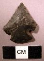 Point of black flint. Convex base, corner-notched.