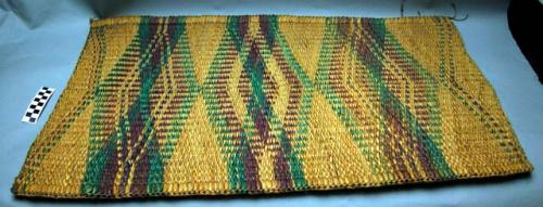 Fiber mat, natural color background with purple and green geometrical pattern.