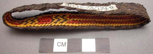 Basketry arm band - dark brown with red & yellow design