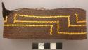 Basketry arm band - brown with yellow design (unfinished?)