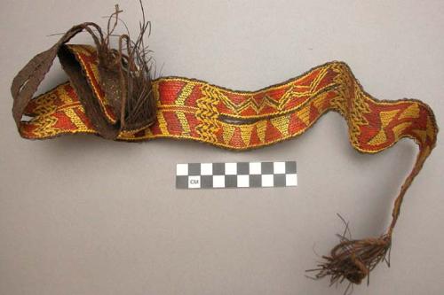 Wide basketry belt with slit at sides--brown with red and yellow design