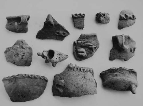 Fragments of miniature vessels and (#2, 8) of larger peices, all of red-on-buff