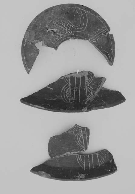 Fine red bowl sherds; red incised cover (3)