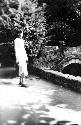 Woman standing beside bridge