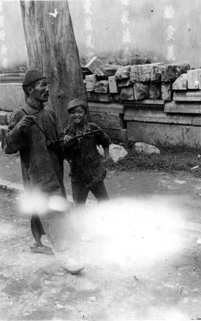 Man and boy walking on street