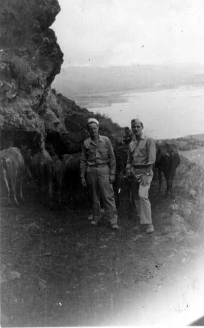 Men in front of lake