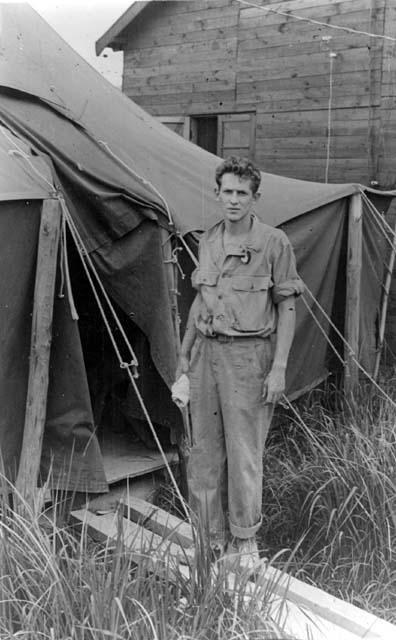 Man in front of tent