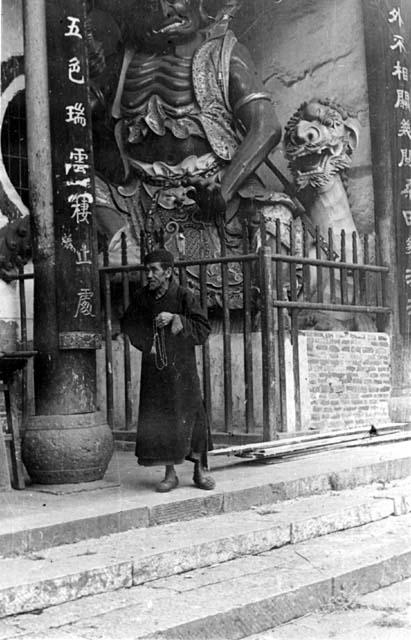 Man in front of statue