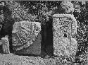 2D9. Panel #3. Not in situ the two sculptured stones lean against the