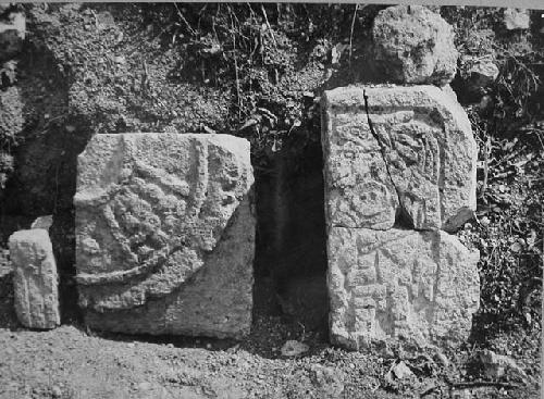 2D9. Panel #3. Not in situ the two sculptured stones lean against the