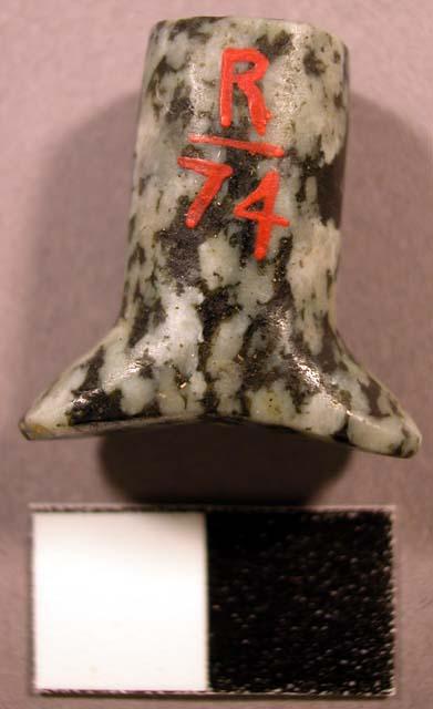 Ground syenite labret. Head is oval-shaped, flared, and concave.