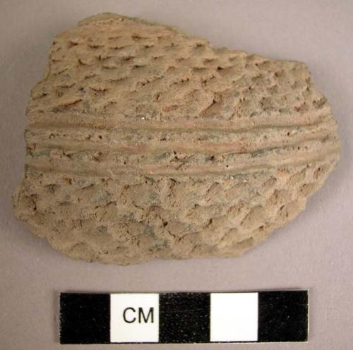 Punched and smooth corrugated grey potsherd