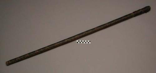 Spear, shaft, carved wood covered with snake skin, 1 end notched, wrapped