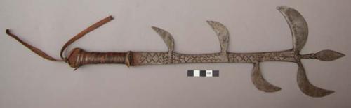 Engraved dagger with 5 prongs; no sheath; leather handle and thong