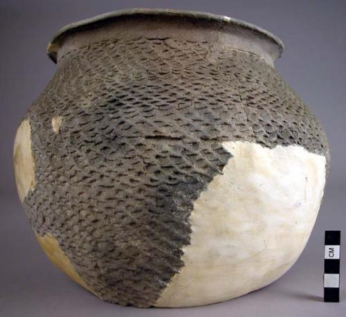 Restored portion and sherds of a grey corrugated pottery vessel