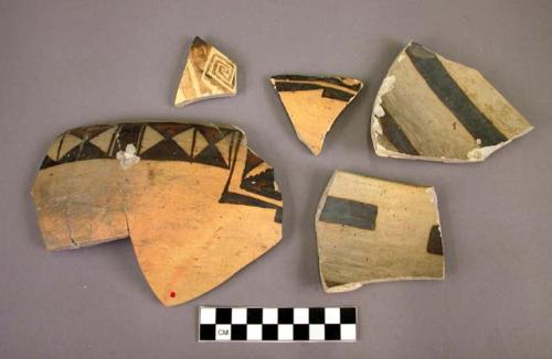 Fragments of black-on-yellow pottery bowl