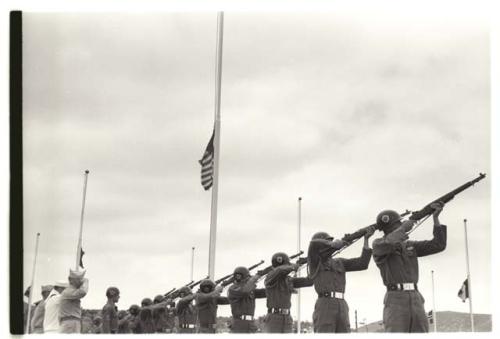 Soldiers firing rifles during ceremony at U.N. cemetery