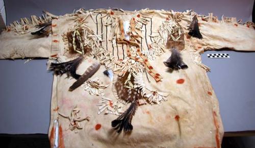 Man's buckskin shirt, fringed. Ornamented with grouse feathers.