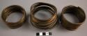 3 coiled brass armlets (identical)