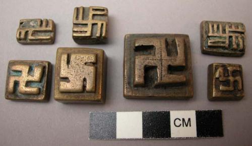 Cast brass or bronze stamps(?), swastika figure