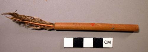 Reed tube with feathers inserted