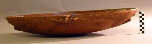 Wood bowl with incised designs, natural wood color, 24 in. l. x +