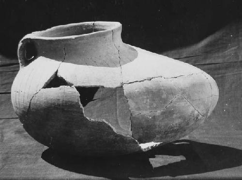 Red-on-Brown , incised + punctated shoe-shaped jar. form Pit #1, Finca Las