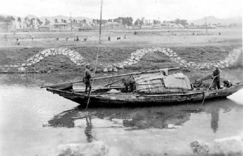 Two people rowing a boat