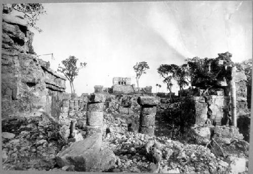 Castillo looking East. through columns of South wing of Temple 21