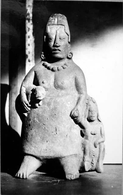 Figurine, ceramic, standing woman holding dog and hand of child at her left