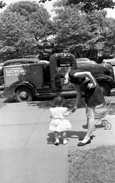 Woman with small girl near truck