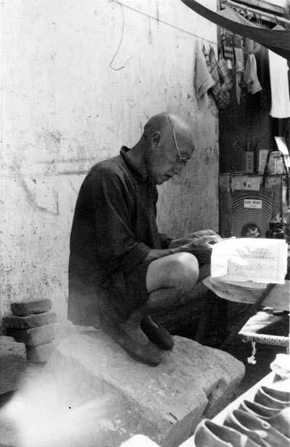 Man crouching; titled "Scribe, reader; etc. Professional"