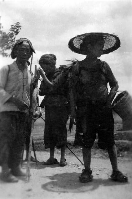 People with baskets; titled "From the hills"