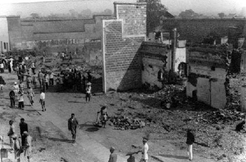 People walking on street; titled "Chinkiang after fire"