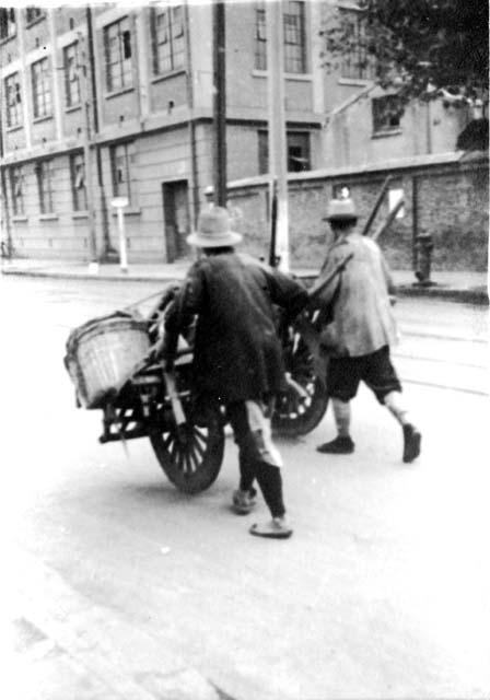 Men pushing carts; titled "Truckers"