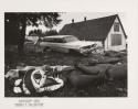 Ketchikan, Alaska: totem pole lying on ground with old car in the background